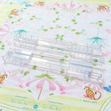 Clear foldable Mahjong tile racks arranged on a floral Mahjong mat