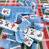 Colorful blue American Mahjong tiles with illustrated designs