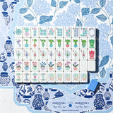 Full set of hand-illustrated Mahjong tiles on a blue chinoiserie mat with a periwinkle acrylic tile