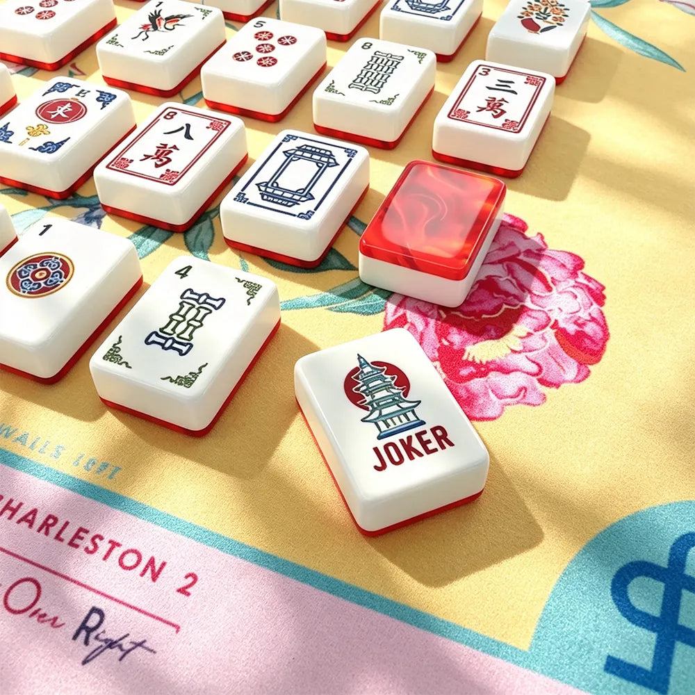 Close-up of red gemstone crane acrylic Mahjong tiles arranged for play