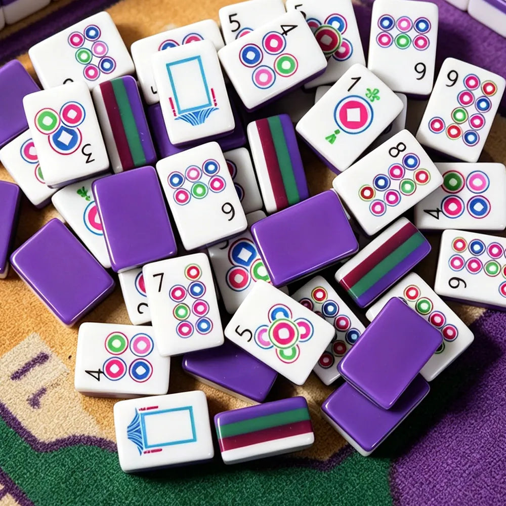 Purple acrylic Mahjong tiles with colourful modern designs arranged on a game table