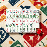 Full Mahjong set arranged in rows on a colourful game table