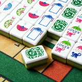 Green and white acrylic Mahjong tiles arranged for a game