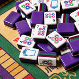 Purple acrylic Mahjong tiles with colourful modern designs on a game table