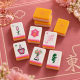 American mahjong tiles with orange and yellow tiles styled on a red and pink background
