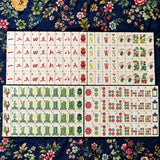 Full Mahjong tile set arranged in neat rows on a dark blue background