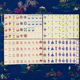Full Mahjong tile set arranged in neat rows on a dark blue background