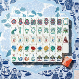 Full layout of hand-illustrated Mahjong tiles on a blue chinoiserie mat with a coral marbled acrylic tile