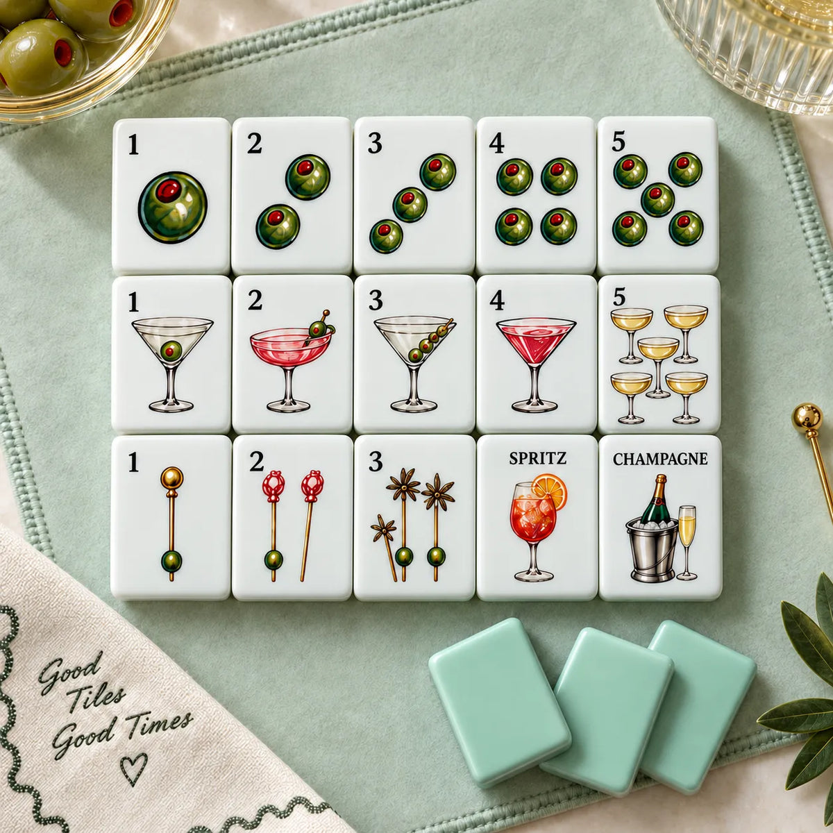 Neatly arranged American mahjong tiles with colourful artwork on a soft green background