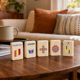 Mahjong tiles displayed upright on wooden stands in a home setting