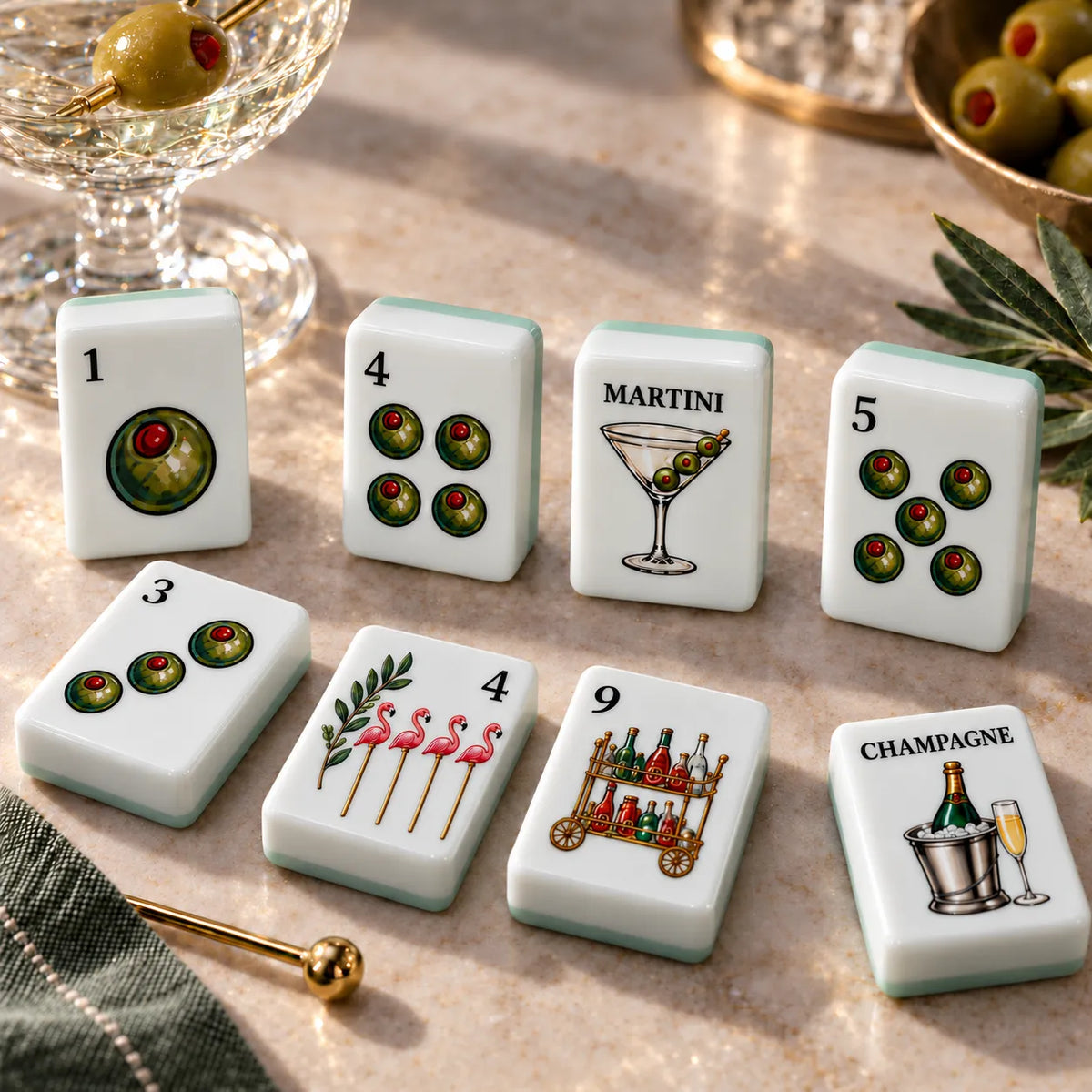 Close view of American mahjong tiles with illustrated artwork styled on a light neutral table
