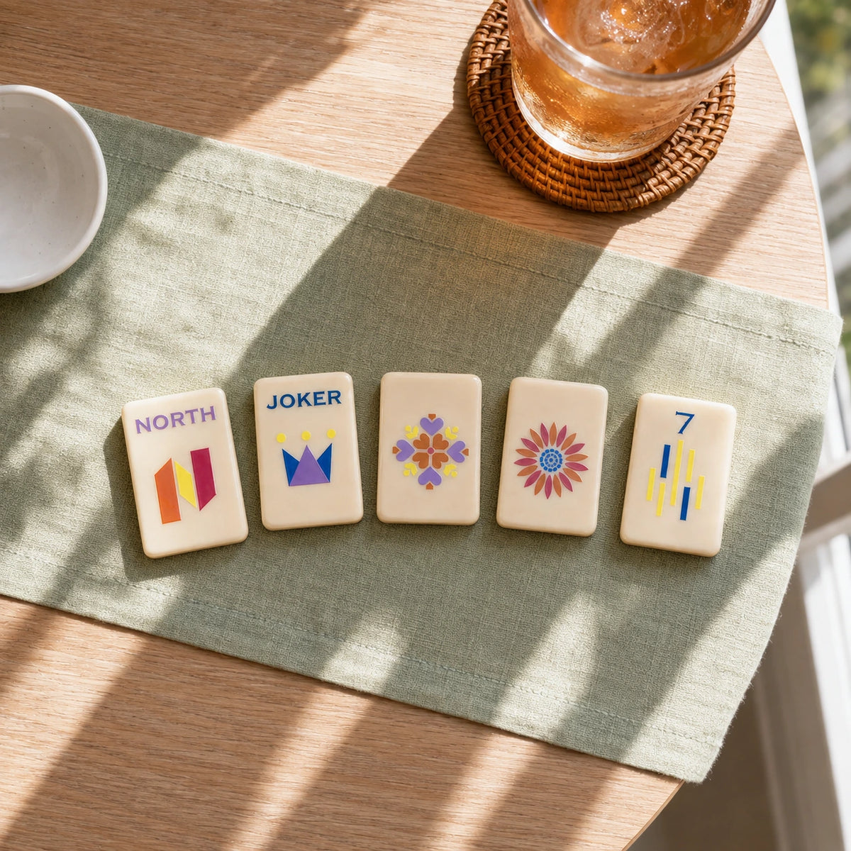 Mahjong tiles displayed on stands with decorative tile designs