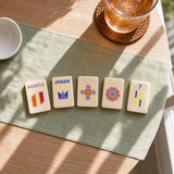 Mahjong tiles displayed on stands with decorative tile designs