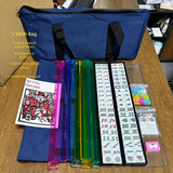 American Mahjong tile set with navy carrying bag and rainbow tile pushers