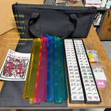 American Mahjong tile set with black carrying bag and rainbow tile pushers