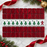 Red acrylic mahjong tile backs with numbered Christmas tree tiles and a gingerbread man tile on marble