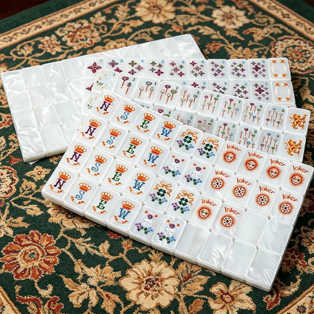 Mother-of-pearl mahjong tile set featuring elegant colourful artwork and a glossy pearl finish displayed on a luxury game table