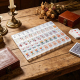 Mother-of-pearl mahjong tile set with elegant colourful artwork displayed on a premium wooden game table