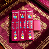 Single-layer neon purple mahjong tile set featuring custom joker designs and colourful patterns displayed on a luxury game mat