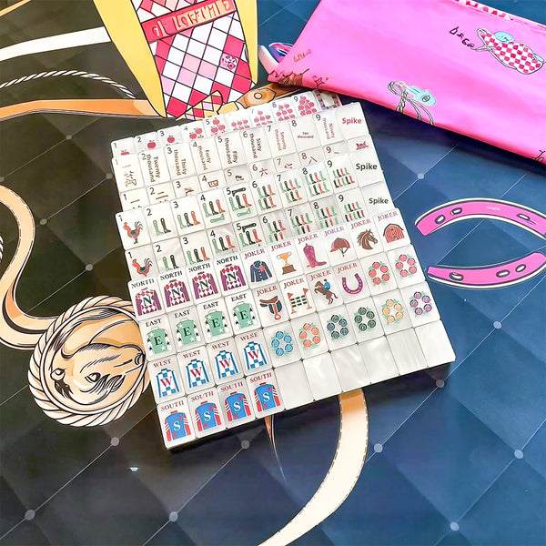 Black and pink mahjong set displayed with elegant accessories