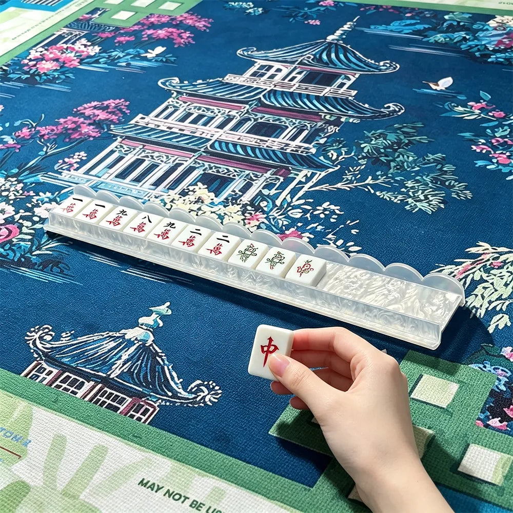 Mahjong tile pusher tool displayed with stacked tiles on a traditional mahjong table