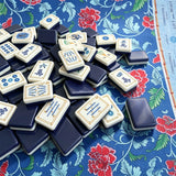 Blue mahjong tile set arranged in a premium display