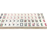 Close-up of white American Mahjong tiles showing traditional symbols and characters