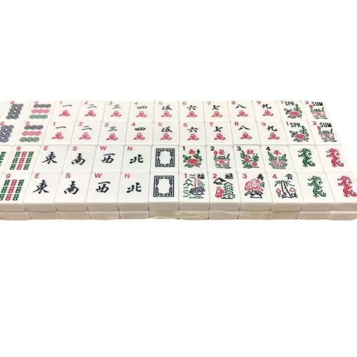 Close-up of white American Mahjong tiles showing traditional symbols and characters