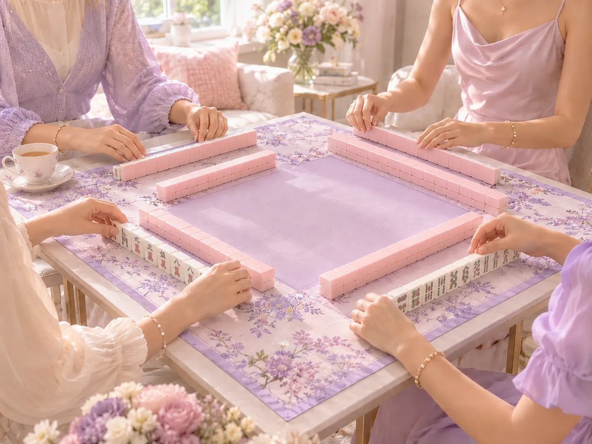 Pink American mahjong tile set on floral tablecloth with tea