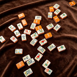 Luxury brown mahjong set displayed with elegant wooden accessories