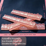 Pink acrylic mahjong tile pusher displayed with mahjong tiles on a decorative game table