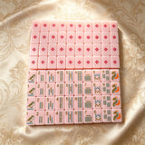 Pink mahjong set displayed in an elegant storage case