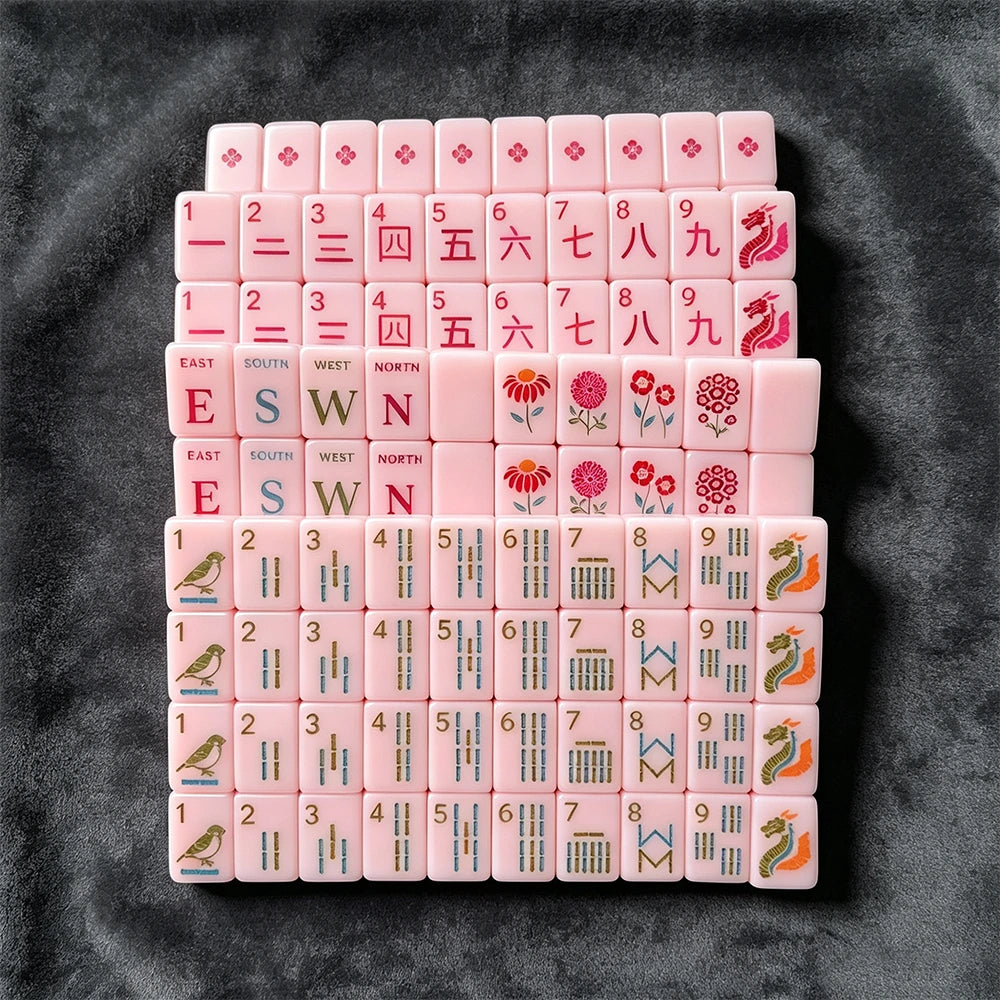 Pink mahjong tiles arranged in a stylish storage case