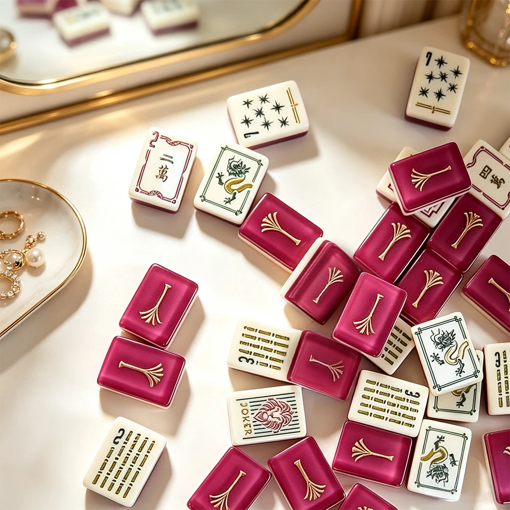Pink mahjong tile set displayed with elegant accessories