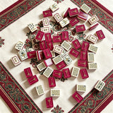 Red mahjong tile set arranged in a luxury display setting
