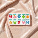 Soft pink mahjong set displayed with elegant accessories
