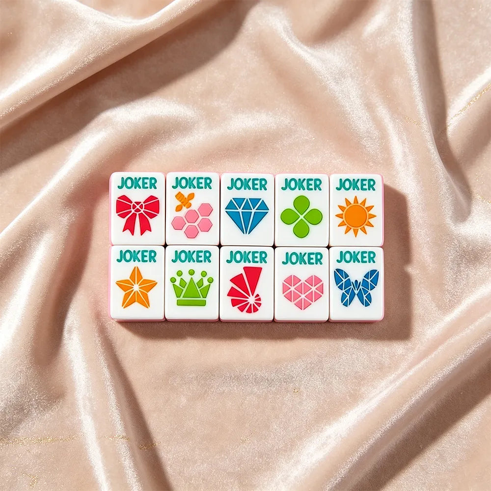 Soft pink mahjong set displayed with elegant accessories