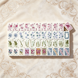 Soft white mahjong tile set with delicate decorative details