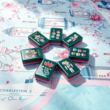 Turquoise mahjong tile art display with decorative patterns