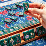 Vibrant blue mahjong play area with colorful tile details