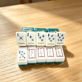 Green mahjong tiles arranged in a stylish close-up display